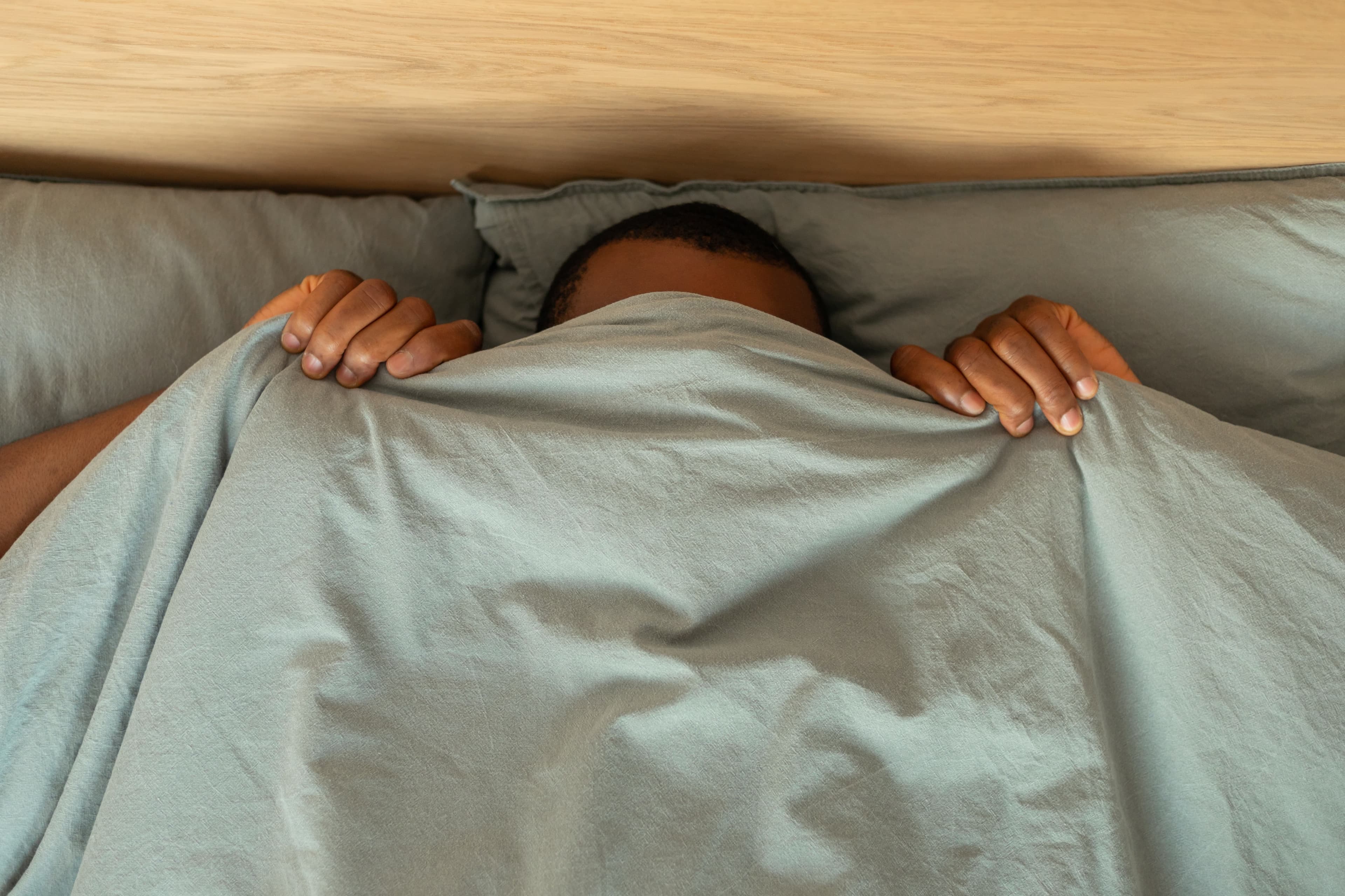 A man hiding under Leesa sheets