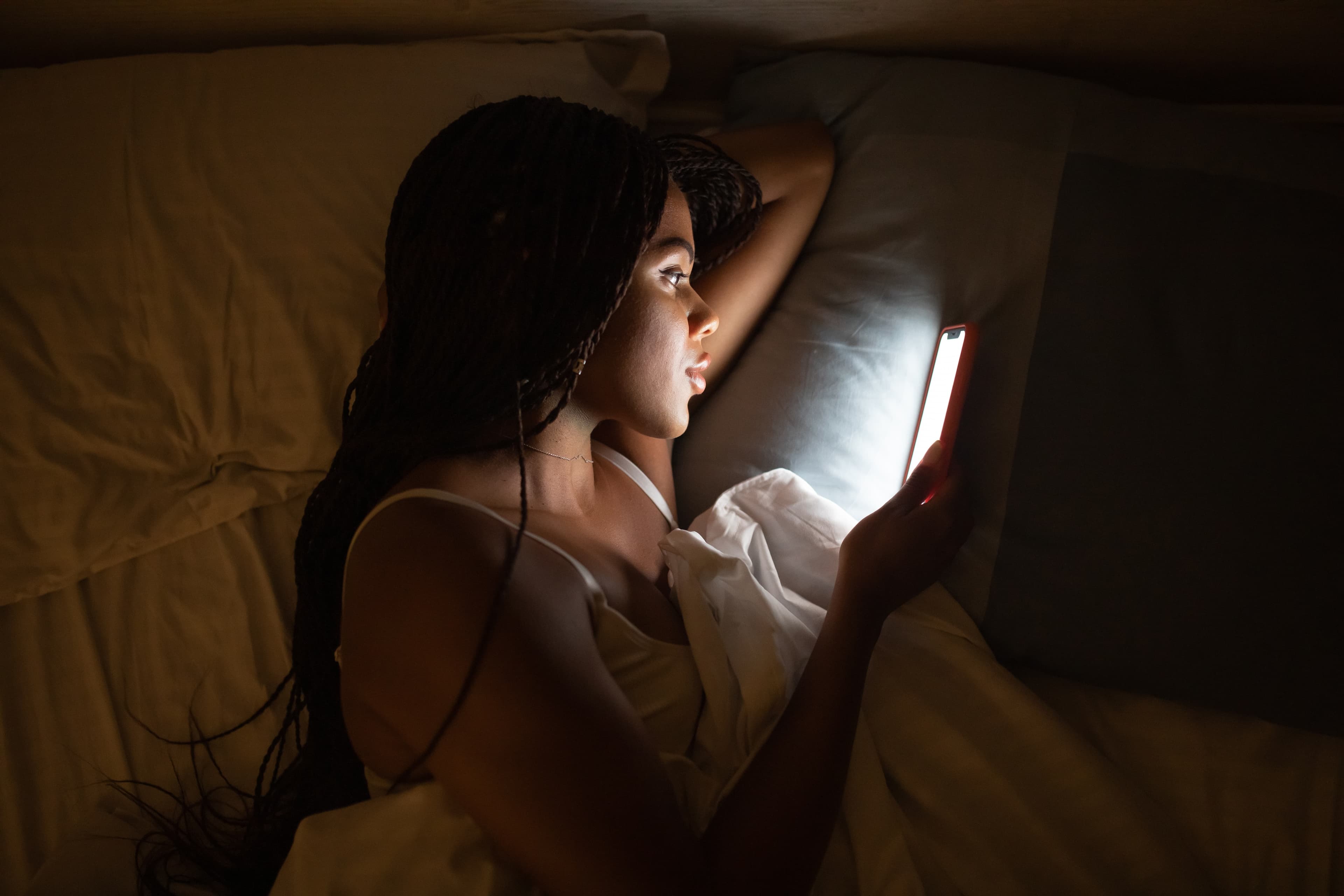 A woman reading in bed on her Leesa mattress