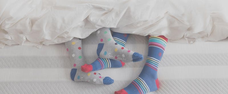 feet_covered_in_socks_in_a_leesa_bed