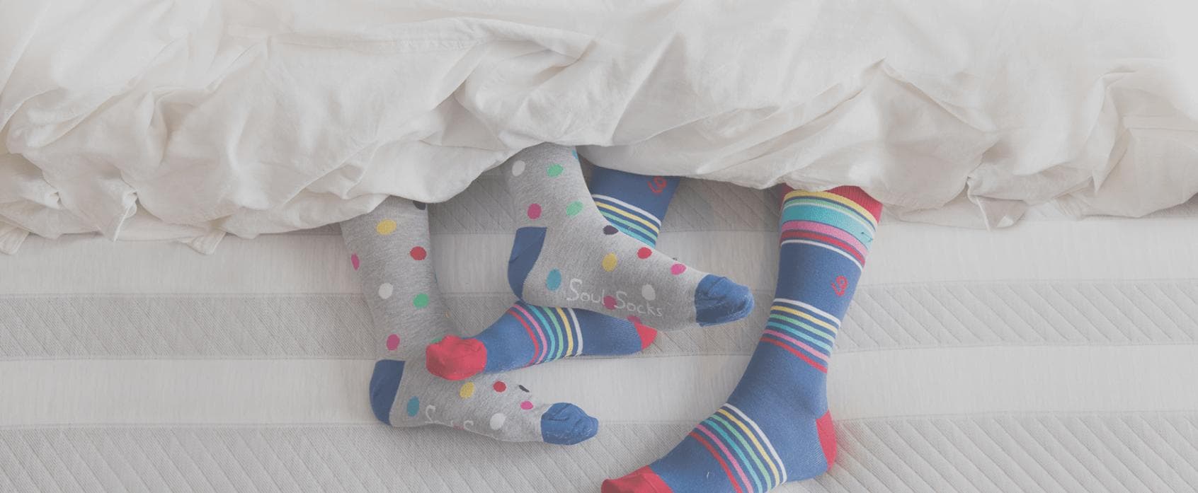 feet_covered_in_socks_in_a_leesa_bed.jpg
