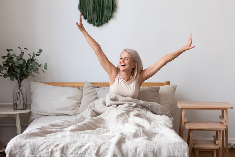 Woman waking up in her mattress