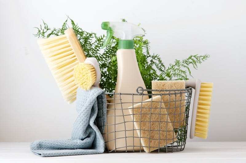 A basket of natural cleaning supplies for deodorizing a mattress