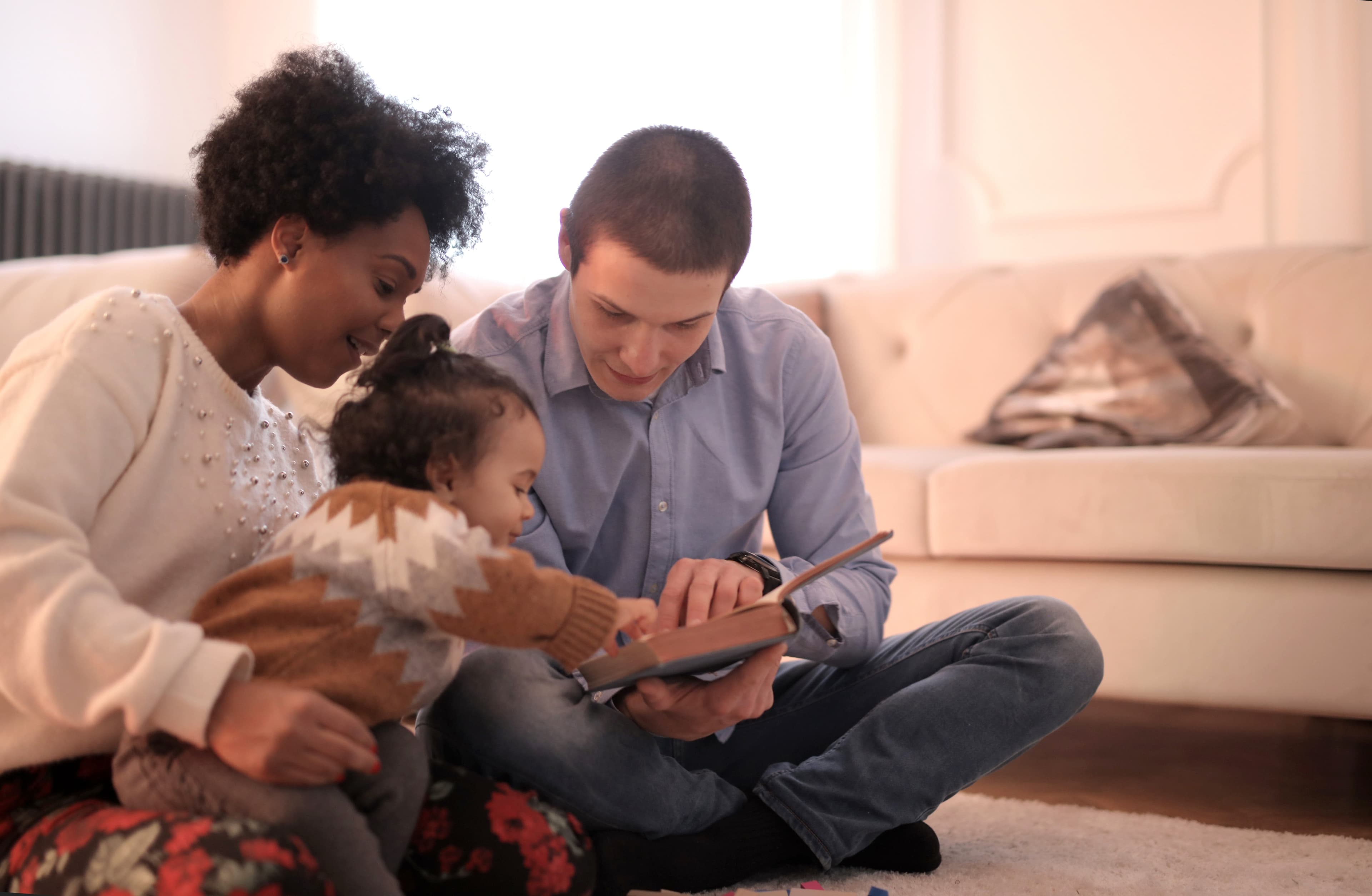 A family reading a book on their Leesa mattress