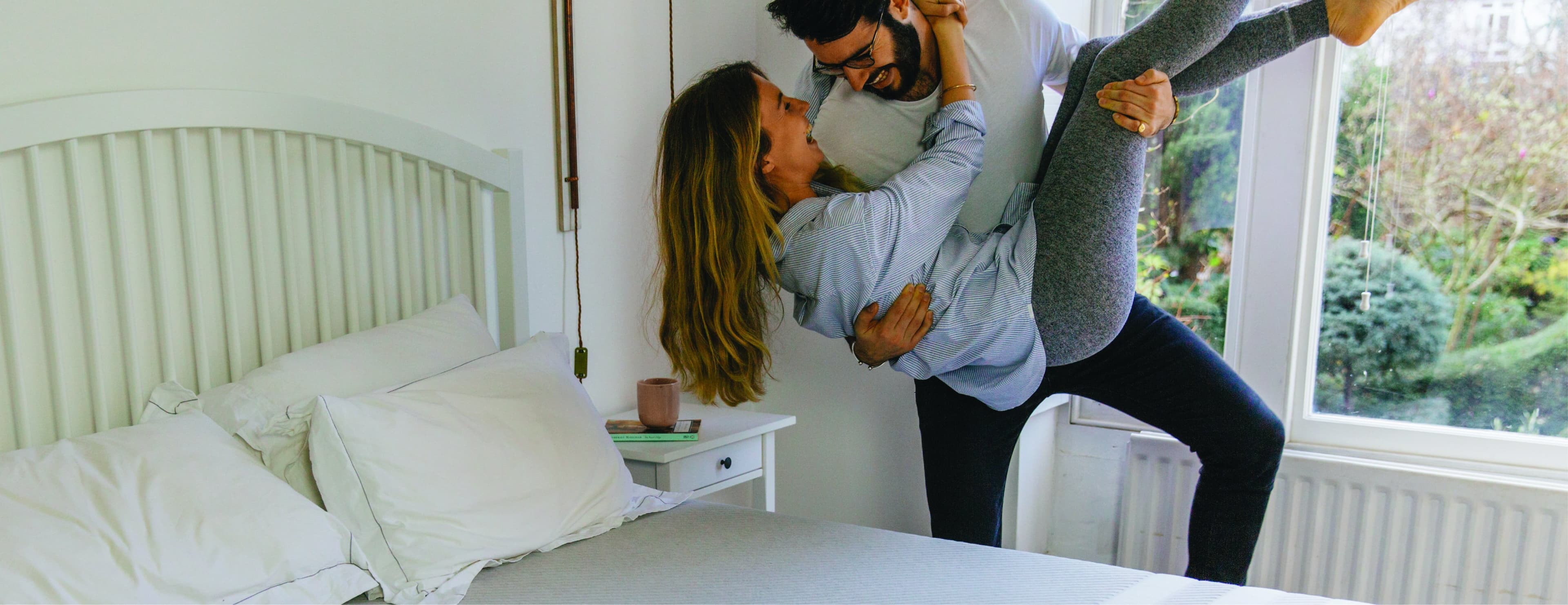 A couple playing around on their Leesa mattress