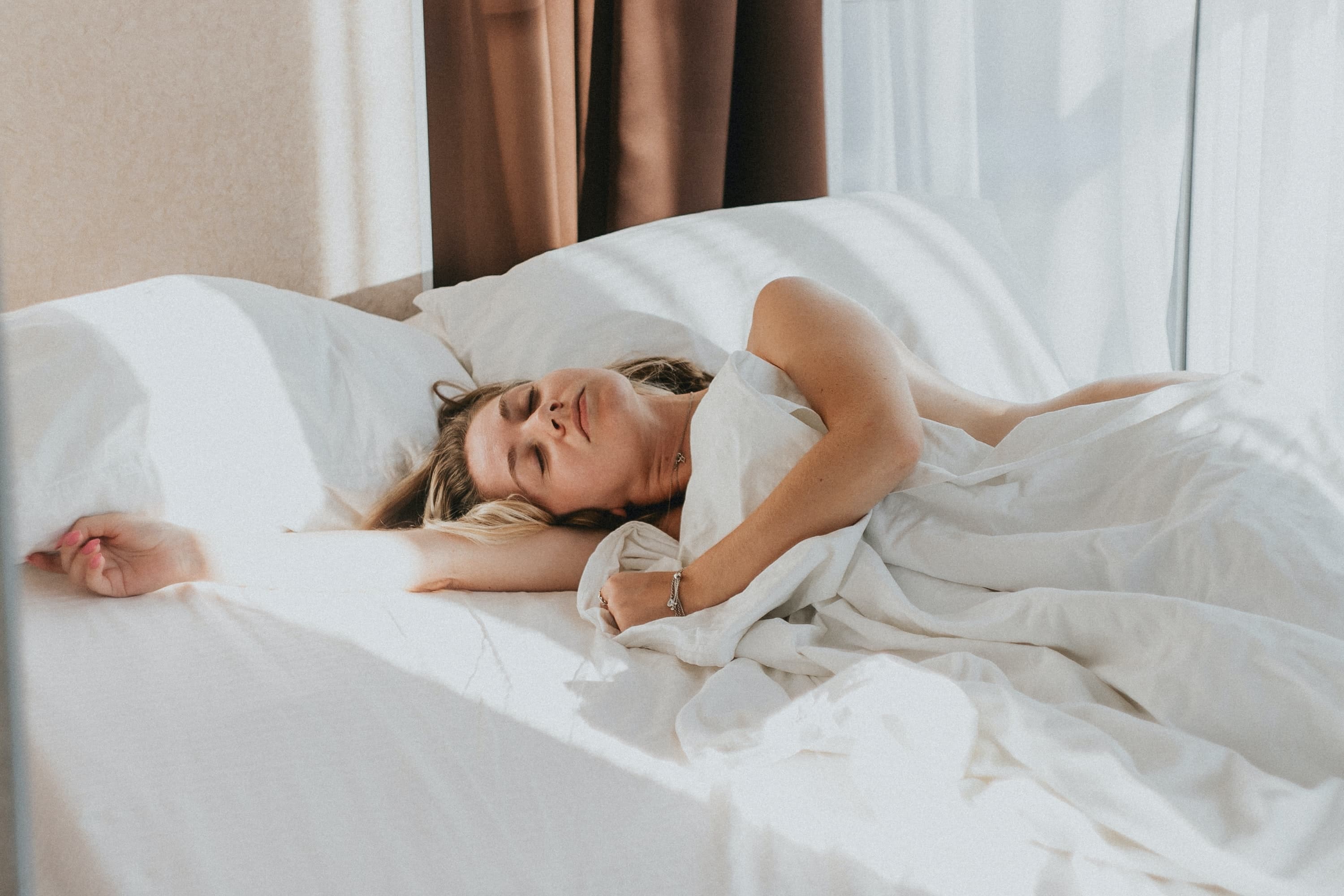 A woman sleeping in her Leesa bed