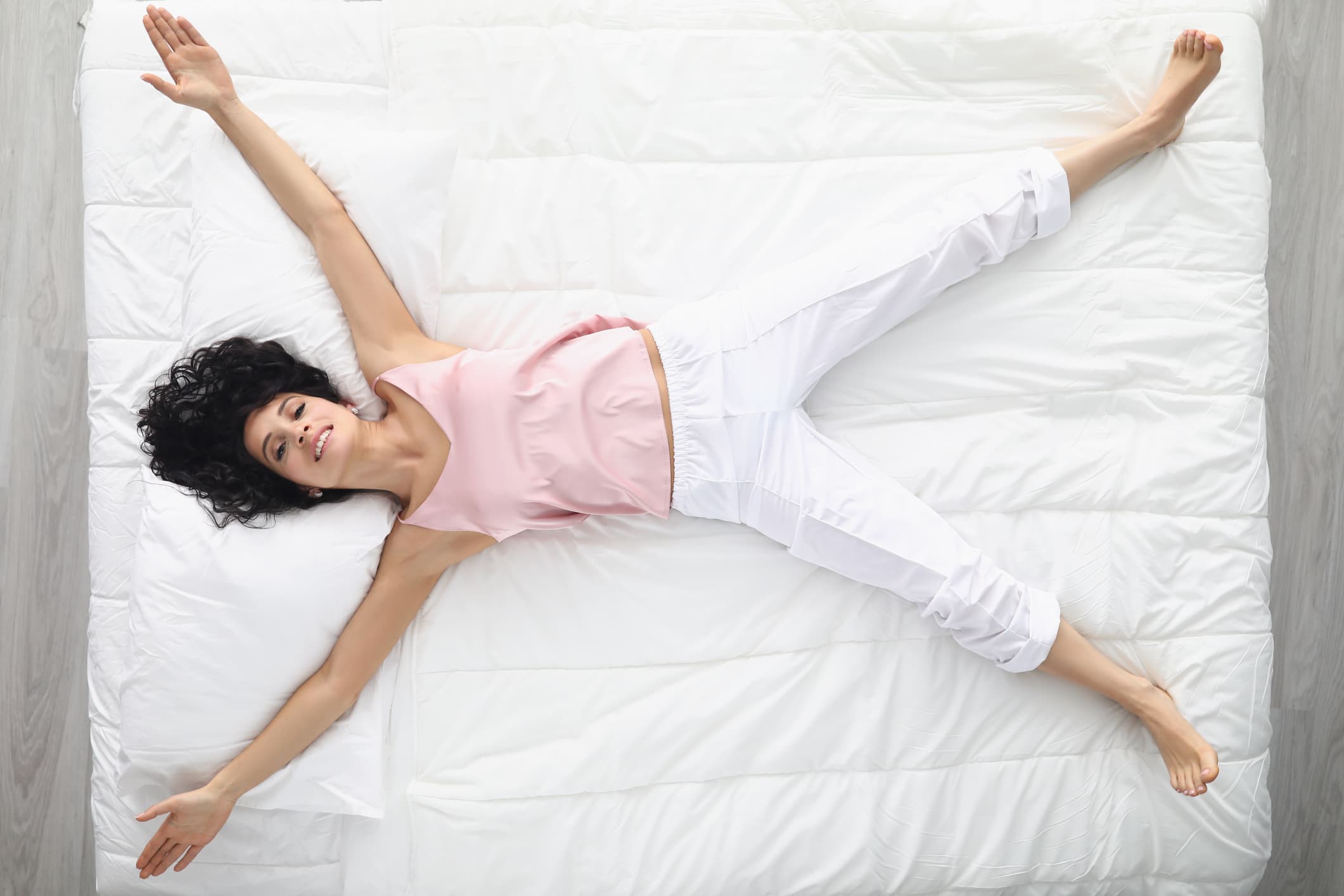 Woman lying on a queen bed