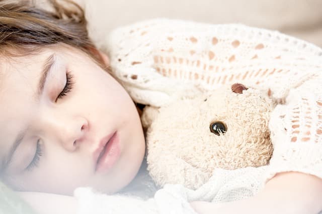A child napping on their Leesa kids mattress