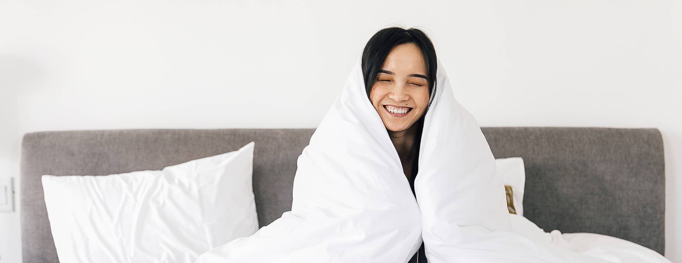 A woman enjoying the Leesa comforter