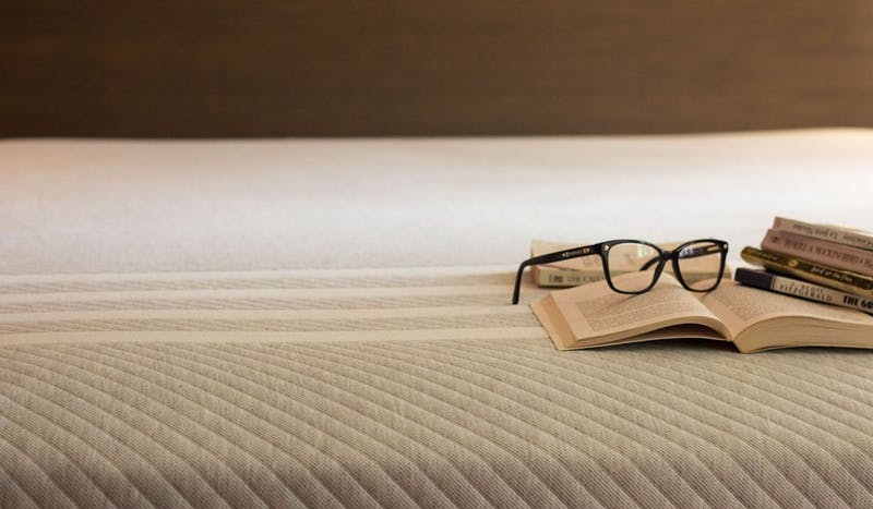 leesa_mattress_with_books_and_reading_glasses