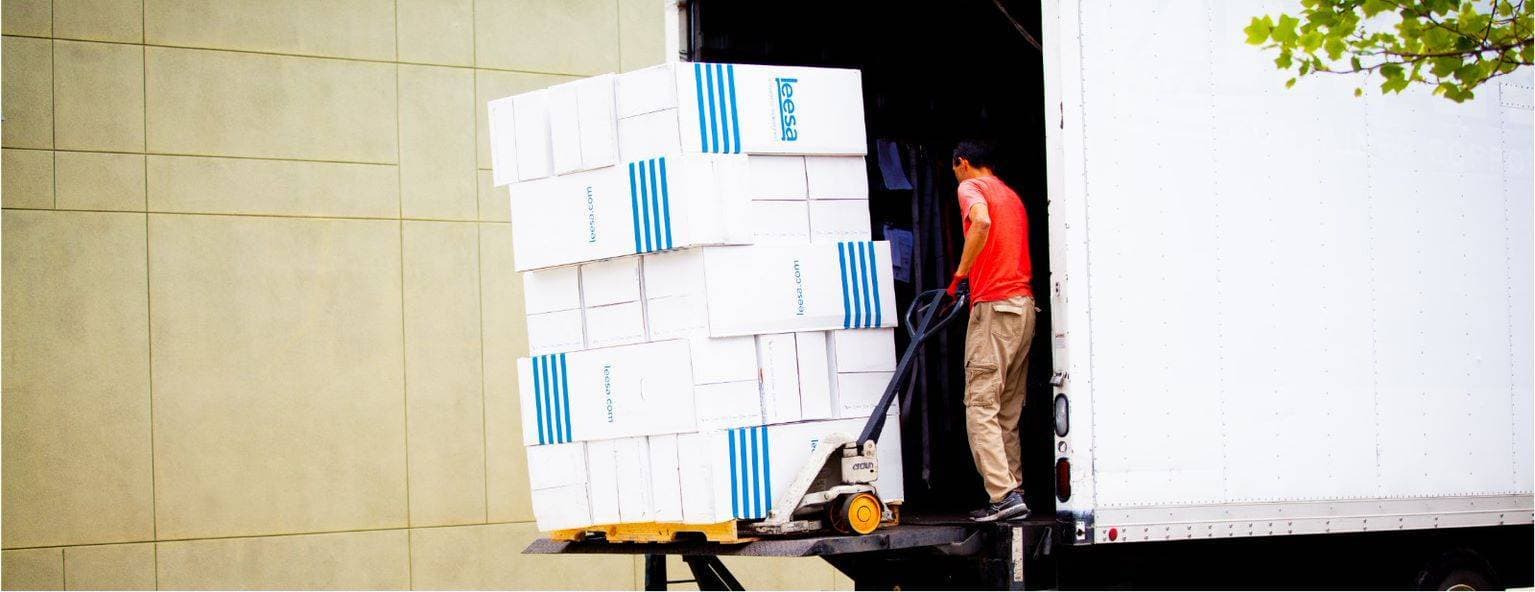 Loading a truck with Leesa mattresses to donate