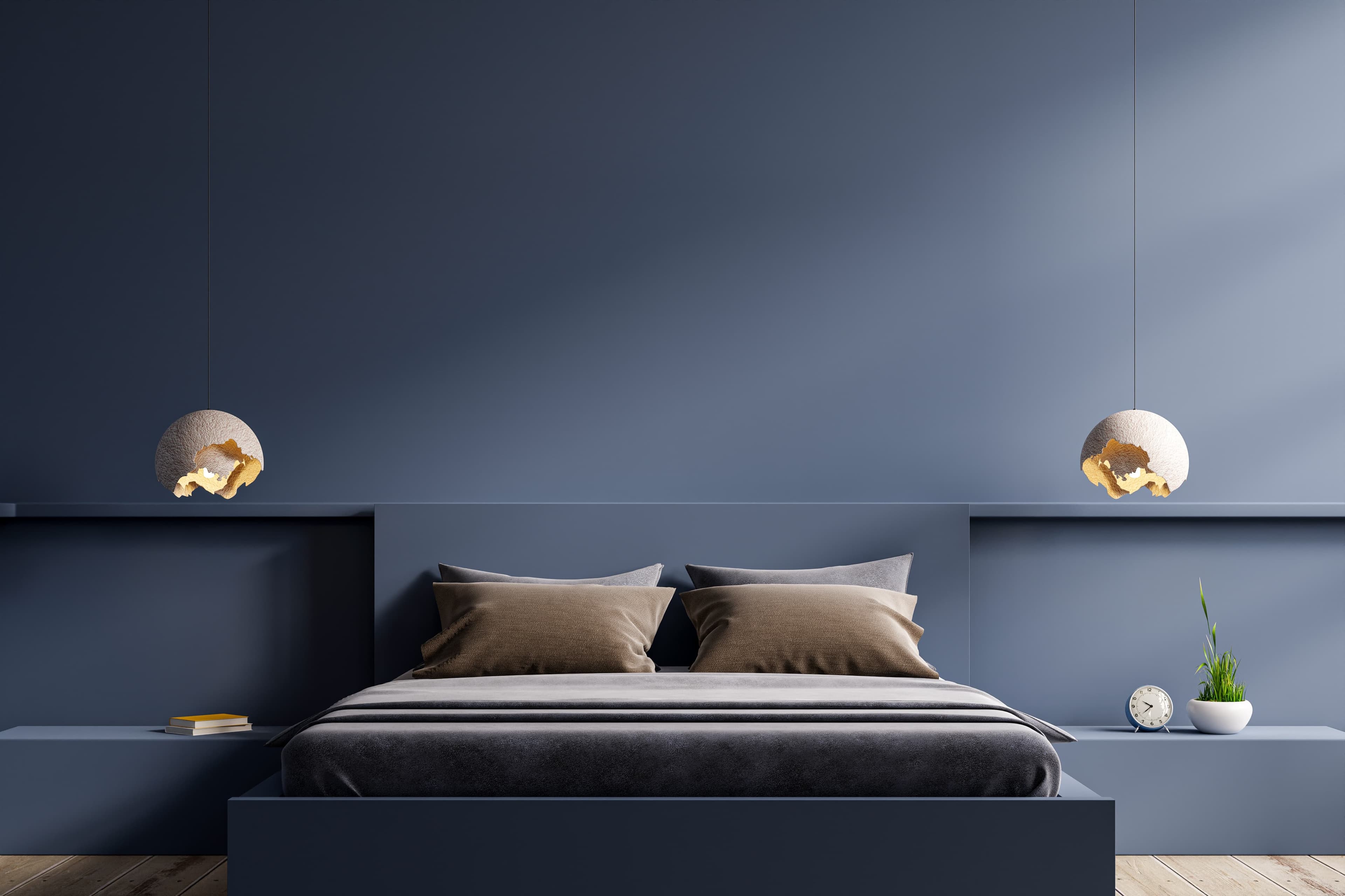 A navy painted bedroom with queen bed, 4 pillows and fitted sheets