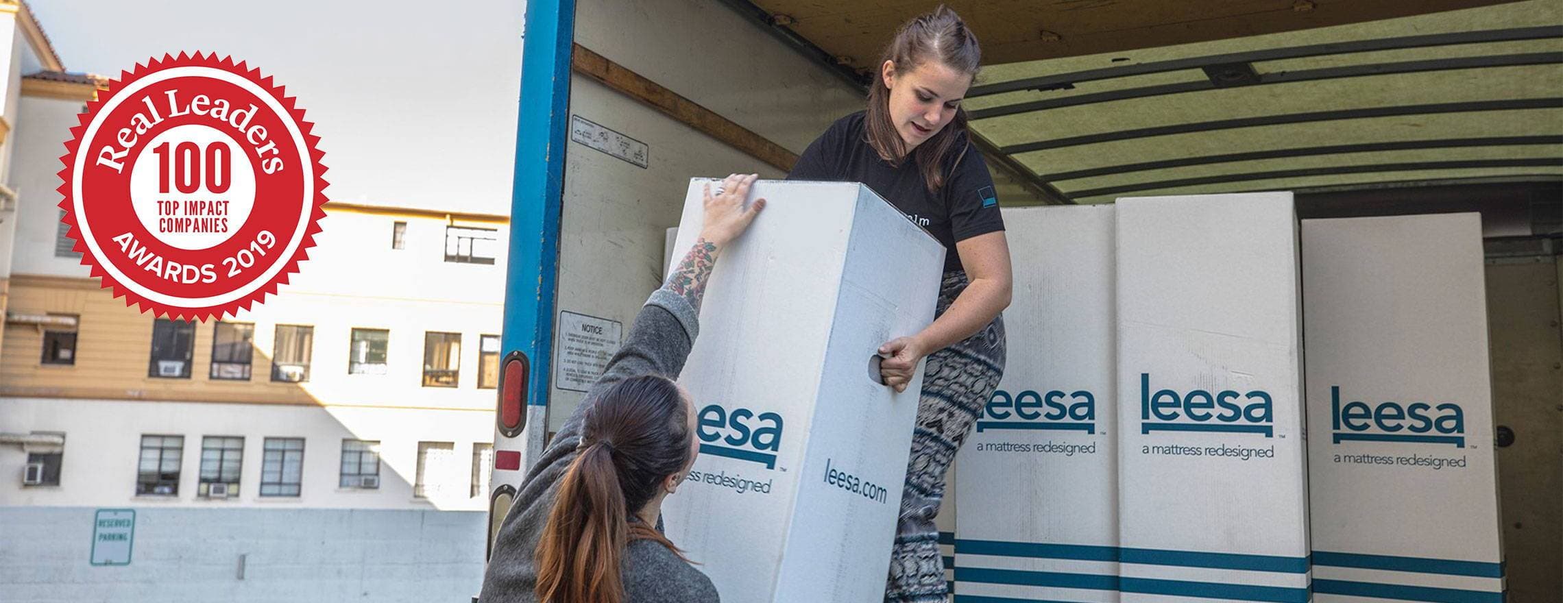 Ladies unloading a Leesa truck to help donate
