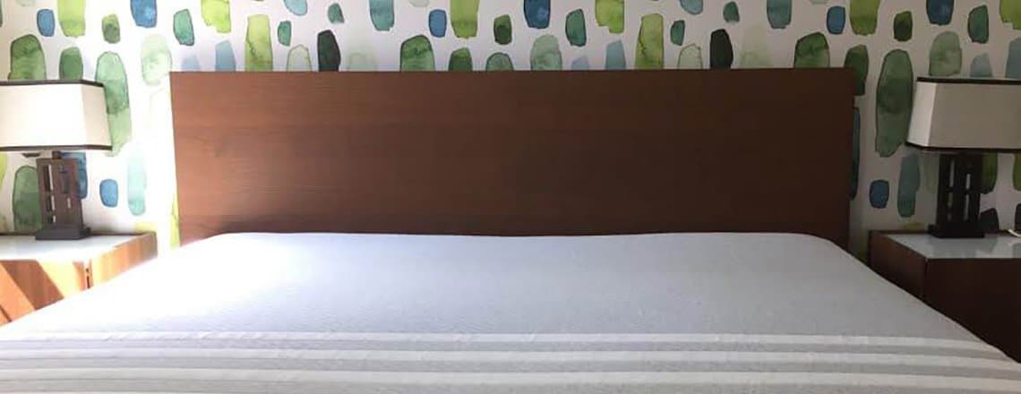 Leesa mattress in a green, blue, and brown decorated bedroom