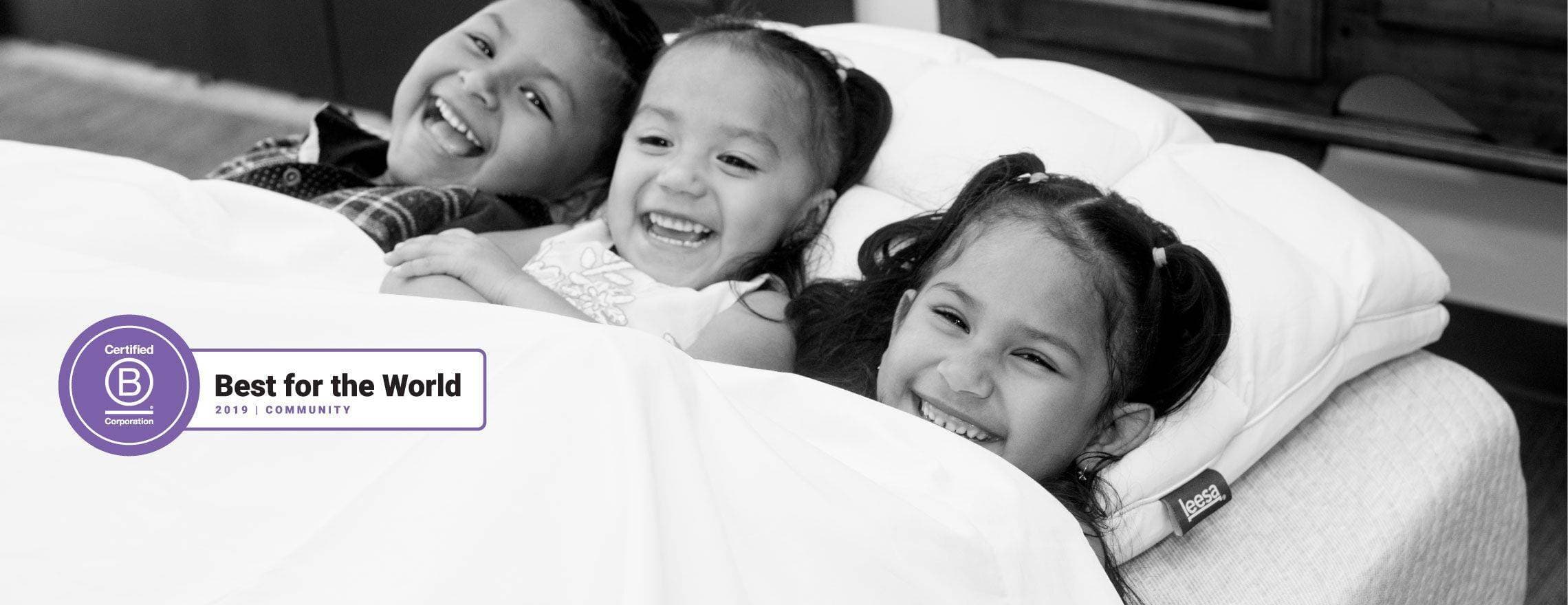 Smiling children in a Leesa bed and certified b corporation logo