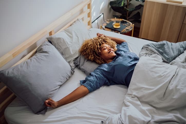 A Woman Having a Lazy Weekend in her Leesa Bed