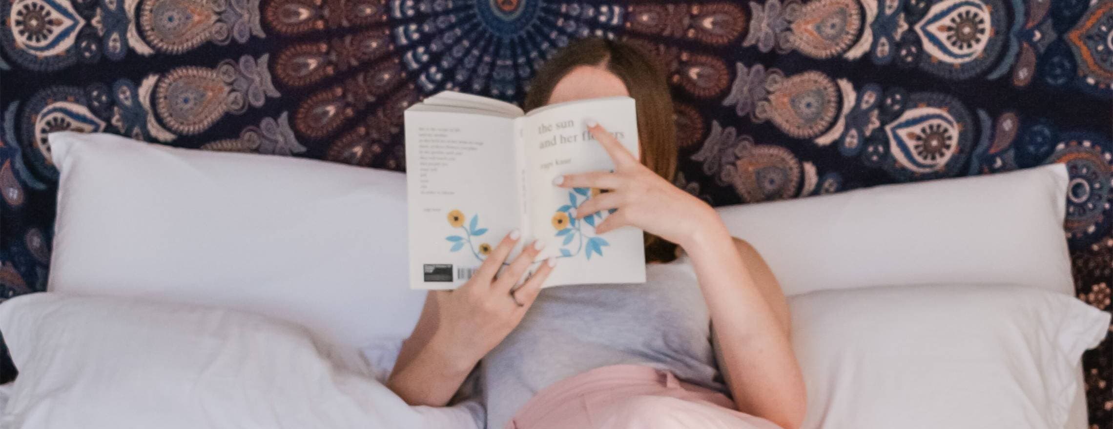 Lady reading a book in a Leesa bed