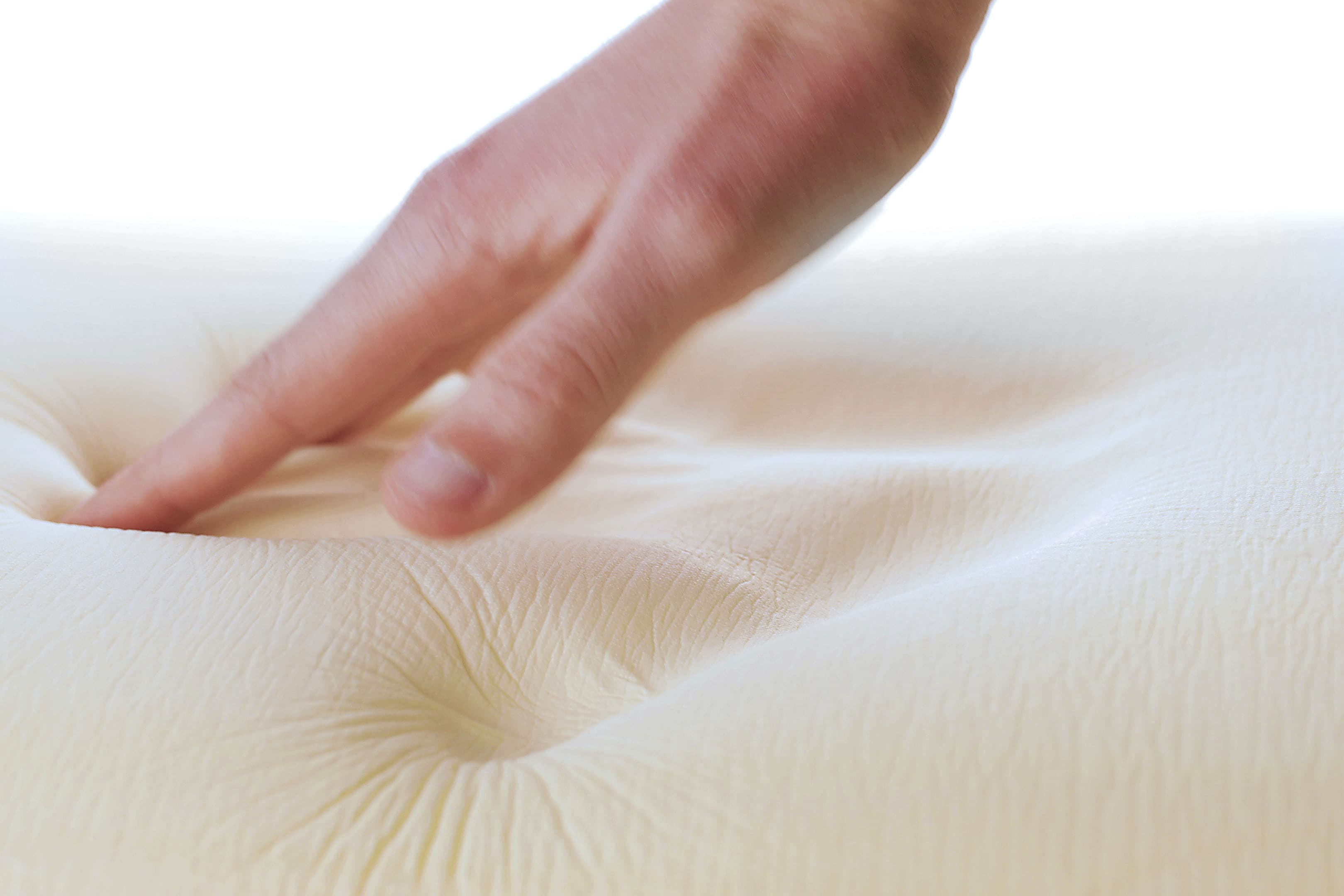 A hand testing Leesa memory foam