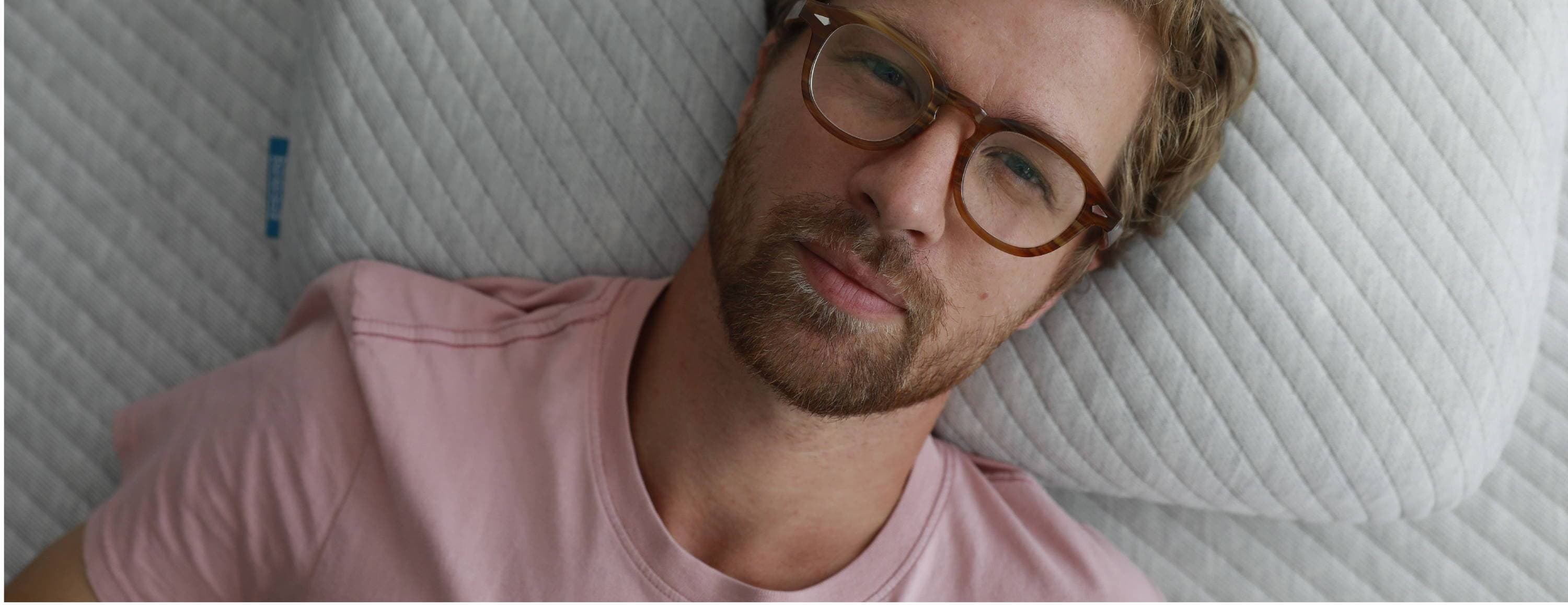 A man lying down on a Leesa mattress