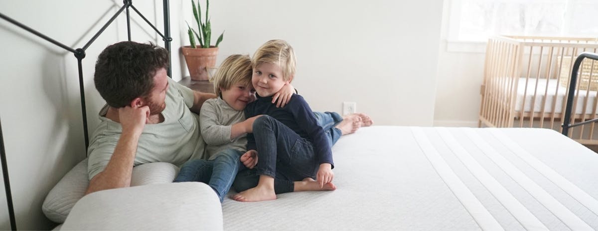 father_and_sons_on_a_white_leesa_mattress_and_pillows