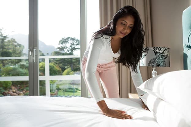 A woman making her Leesa bed